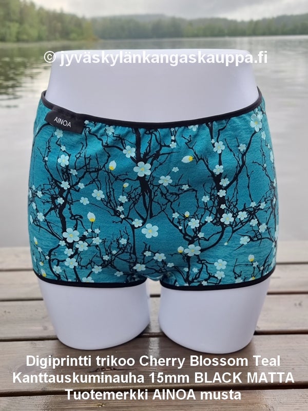 Digiprintti trikoo Cherry Blossom Teal ja Kanttauskuminauha 15mm BLACK MATTA sek&auml; Tuotemerkki AINOA musta
